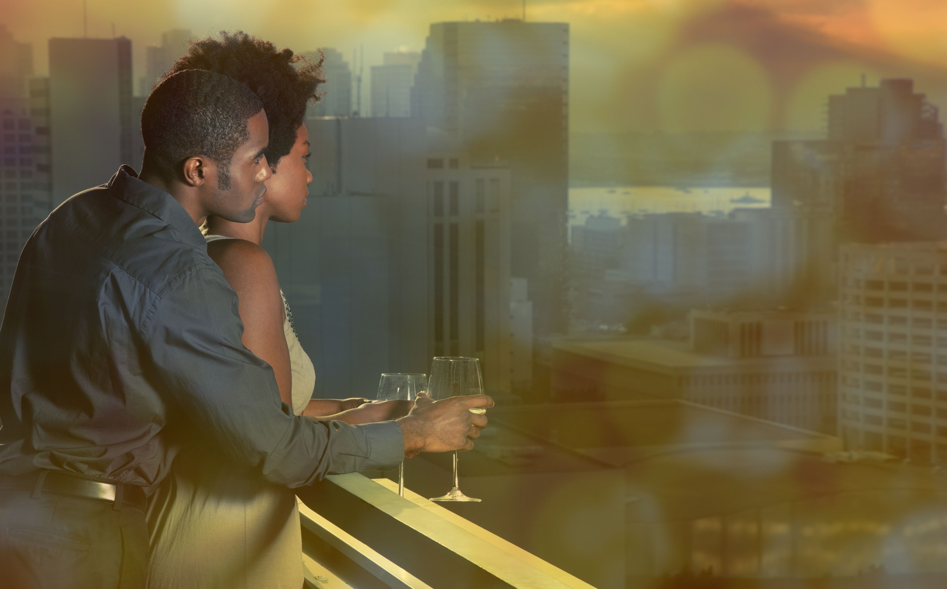 African American couple on a balcony overlooking downtown San Diego